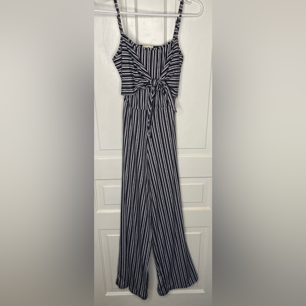 Derek Heart, black and white stripped jumpsuit. SMALL